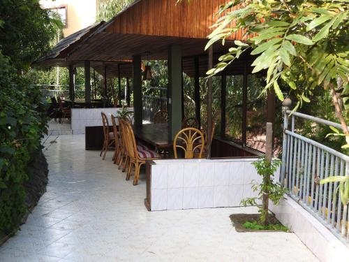 a pavilion with chairs and tables on a patio at Misty Mountain Lodge in Naro Moru