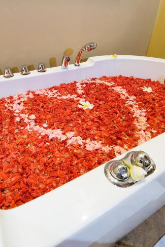 a bath tub filled with red peppers in a sink at Ajanta Villa in Sanur