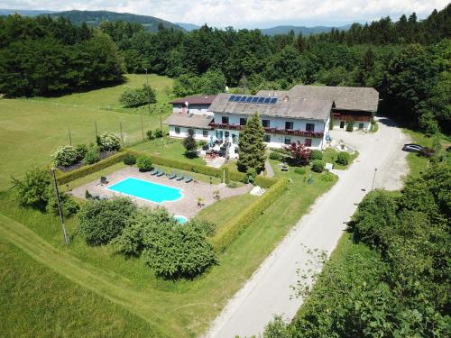 an aerial view of a house with a swimming pool at Gasthof Waldwirt in Sankt Kanzian