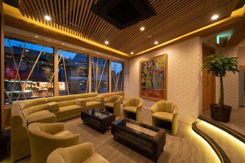 a living room with a couch and chairs and a table at Terrace Kiyomizu Kyoto in Kyoto