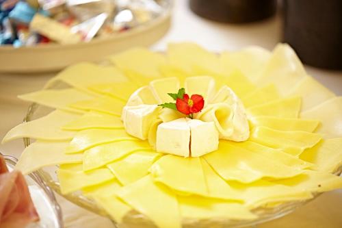 a plate of cheese with a flower on top of it at Penzion Kostnický dům in Tábor