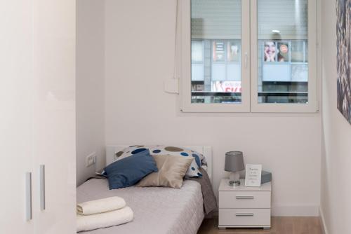 a small bedroom with a bed and a window at Condo Spalato in Split