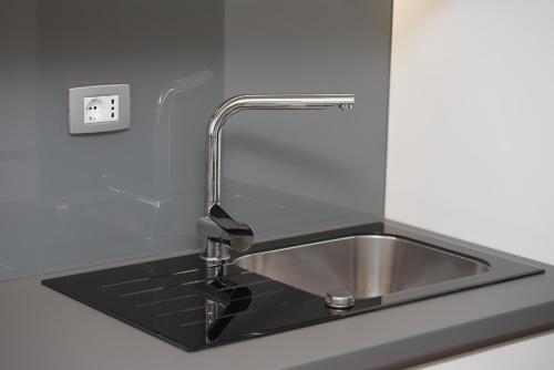 a stainless steel kitchen sink with a faucet at Condo Spalato in Split