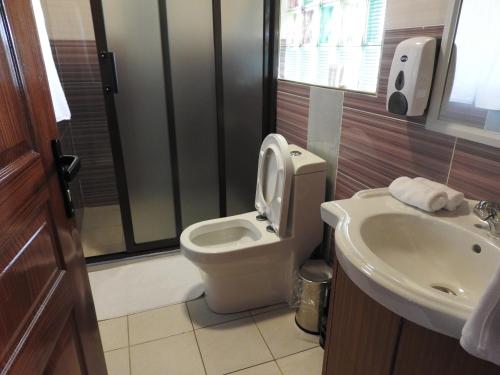 a bathroom with a toilet and a sink at Misty Mountain Lodge in Naro Moru