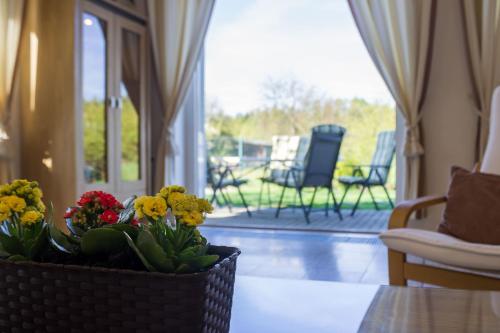 a vase of flowers on a table in a living room at Vila Les Kralovstvi in Nemojov