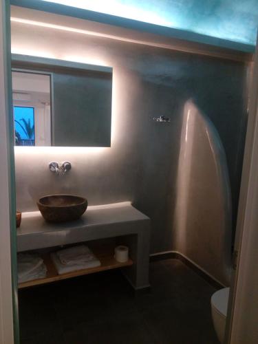 a bathroom with a sink and a mirror at Villa Koronios in Fira