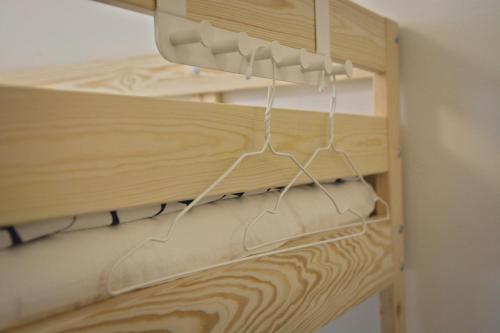 a wooden cabinet with wires hanging from it at GRAN hostel in Banská Bystrica
