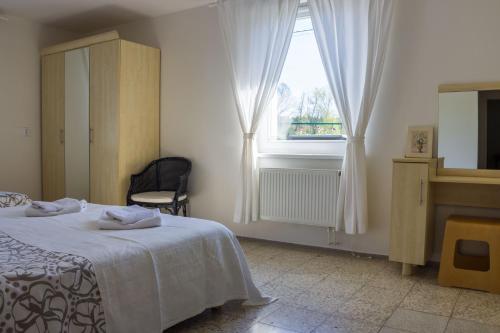 a bedroom with a bed and a window at Vila Les Kralovstvi in Nemojov
