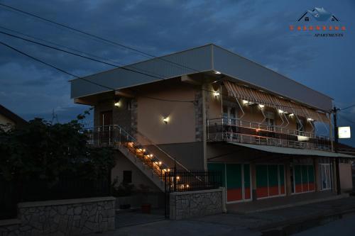 a building with a balcony with lights on it at Valentina Apartments in Gevgelija