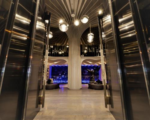 a hallway of a building with a column and lights at Starhaus Hotel in Kaohsiung