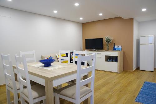 a kitchen and dining room with a table and chairs at A Nossa Praia in Praia da Barra