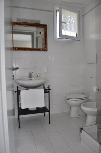 a white bathroom with a sink and a toilet at Ai Marucchi in Celle Ligure