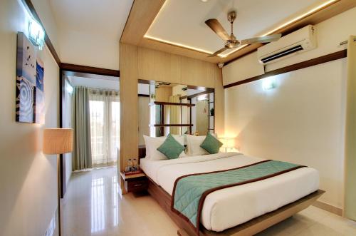 a bedroom with a large bed in a room at White Castle Boutique Apartment Hotel in Bangalore