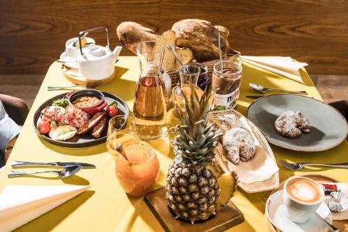a table with a pineapple on a yellow table cloth at Village Resort Hanuliak in Belá