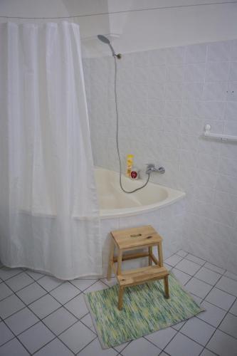a bathroom with a bath tub and a step stool at GRAN hostel in Banská Bystrica