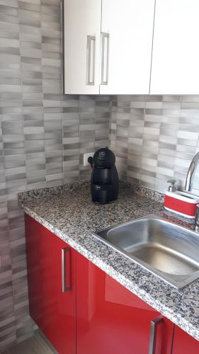 a kitchen with a sink and a counter top at Rocha Apartment Plus in Portimão