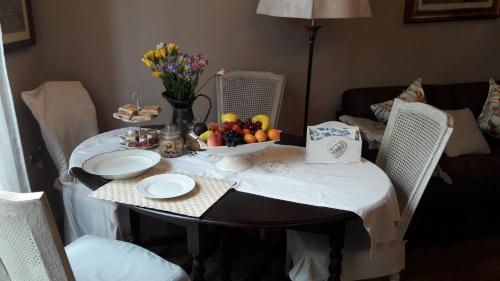 a table with a bowl of fruit on top of it at Caterina Residenza in Ravenna