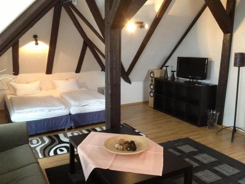 a room with a bed and a table with a plate of food at Parkhotel Helmstedt in Helmstedt