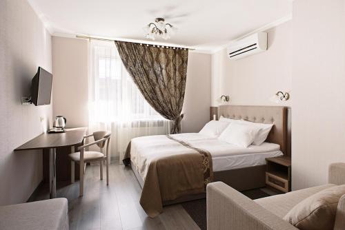 a hotel room with a bed and a table and a desk at Time Hotel in Kyiv