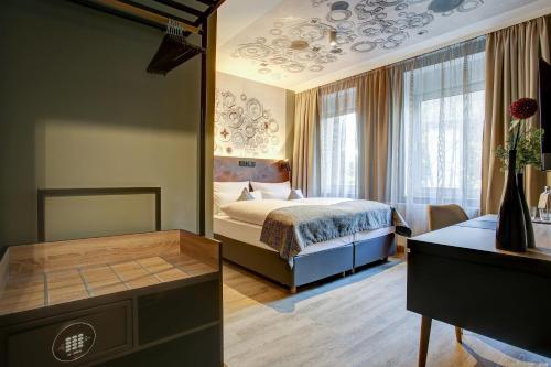 a bedroom with a bed and a table in a room at Boutique Essen City in Essen