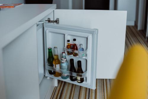 an open refrigerator filled with lots of drinks at Aparthotel Tangerine in Batumi