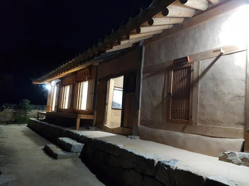 an outside view of a building at night at Jukheon Traditional House in Andong