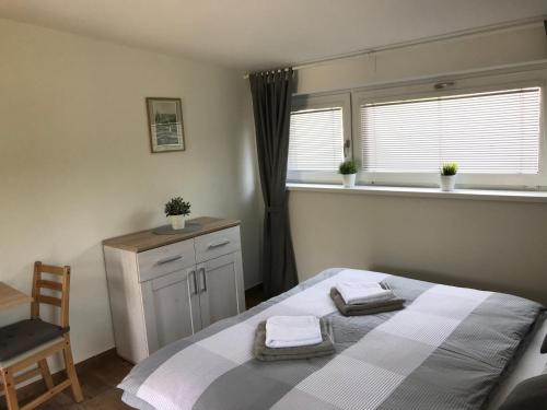 a bedroom with a bed and a window and a chair at Pension SALMA in Český Krumlov