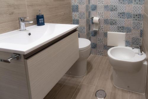 a bathroom with a sink and a toilet at Damahouse in Formia