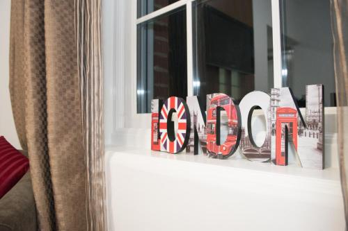 a sign that says london on a window sill at Trivelles Gatwick Hotel & airport Parking in Crawley