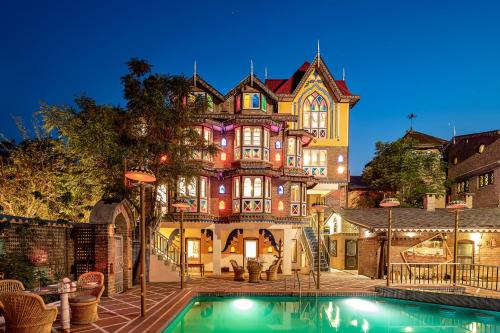 a large house with a swimming pool in front of it at Chateau Garli in Garli