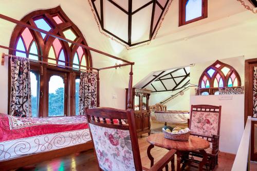 a bedroom with two beds and a table and chairs at Chateau Garli in Garli