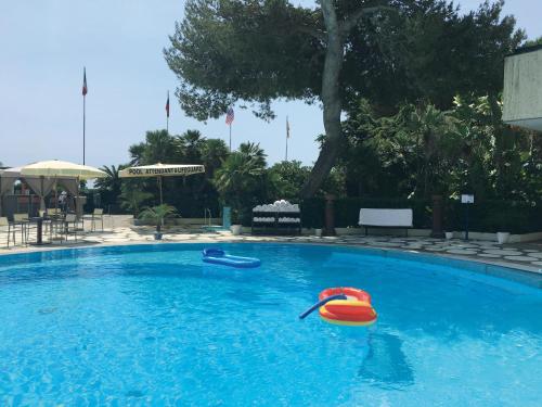 a swimming pool with two inflatable tubes in it at Grand Hotel Del Mare Resort & Spa in Bordighera