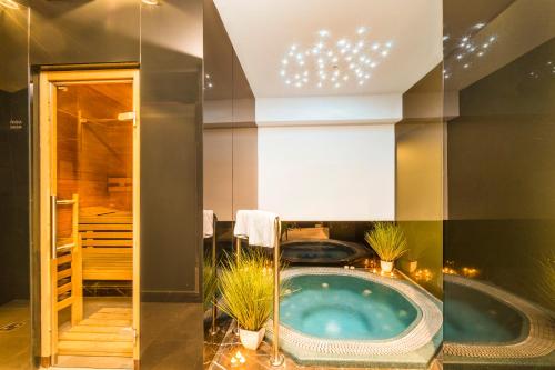 a bathroom with a jacuzzi tub with plants at Rooms Oasis Life in Split