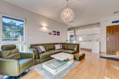 a living room with a couch and a table at Apartament Słoneczny in Międzywodzie