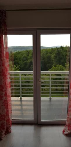 an open window with a view of a balcony at Holiday Home SL in Sarajevo