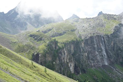 a mountain with green hills and trees on it at Haus Heiss in Prutz