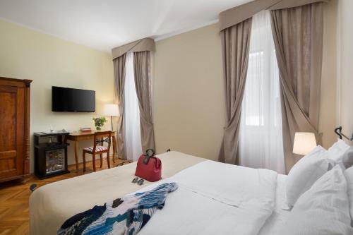 Ένα ή περισσότερα κρεβάτια σε δωμάτιο στο Hotel Angelo d'Oro