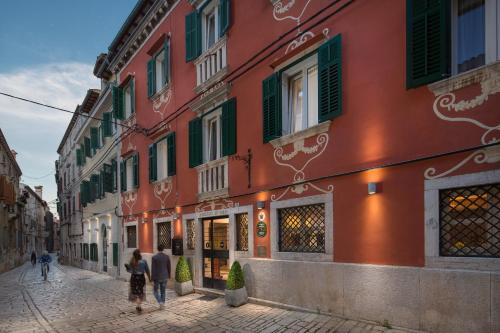 a group of people walking down a street at Hotel Angelo d'Oro in Rovinj