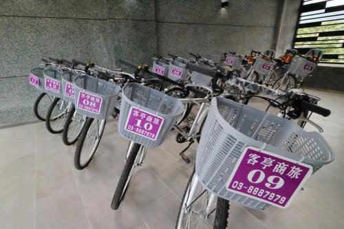 a row of bikes parked in a building with signs on them at KET Hotel in Yuli