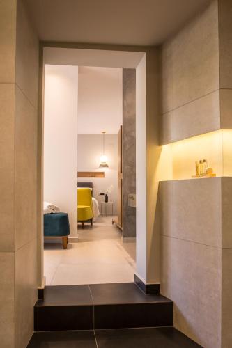 a hallway leading to a living room with a yellow couch at Gambello Luxury Rooms in Nafplio