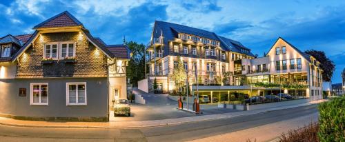 a group of buildings on a city street at AKZENT Hotel Villa Saxer in Goslar