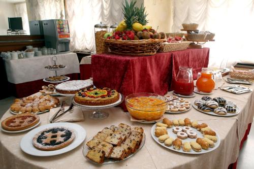 a table with many different types of food on it at Hotel Excelsior in Monfalcone