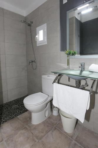 a bathroom with a toilet and a sink at SB Arenal in El Arenal