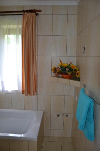 a bathroom with a tub and a sink and a window at Słoneczne Chaty pod Sonami Kasina Wielka in Kasina Wielka