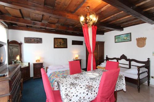 a room with a dining table and a bedroom at Apartments Sebal in Rovinj