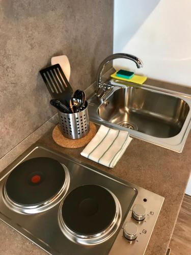 a kitchen counter with a sink and a sink at Barbara’s rooms in Chioggia