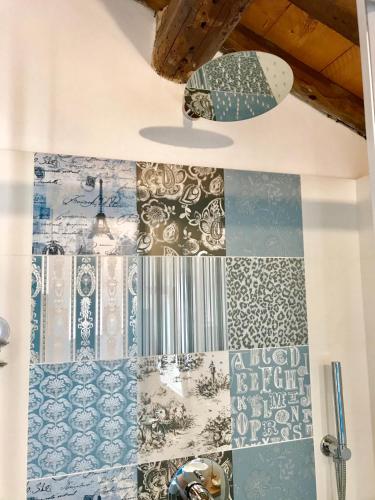 a quilt hanging on a wall with a surfboard at Barbara’s rooms in Chioggia