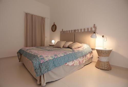 a bedroom with a bed and a table and a lamp at Mediterranean View in Marina di Ragusa