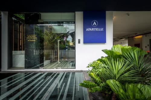 an entrance to a building with a blue sign on it at Apartelle Jatujak Hotel in Bangkok