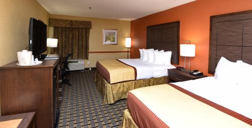 A bed or beds in a room at Best Western Zachary Inn